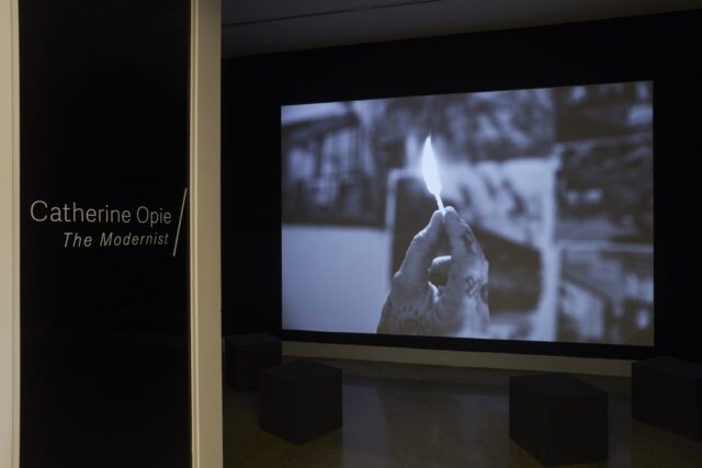 Picture of Catherine Opie exhibition. Outside of gallery showing film by Catherine Opie